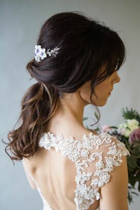 Violet comb white flowers with Swarovski crystal culture centres and little braces of crystals and pearls in brunette wedding hair style