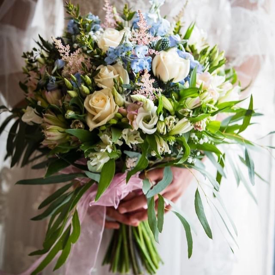 natural leafy pale pink, blue and white wedding bouquet