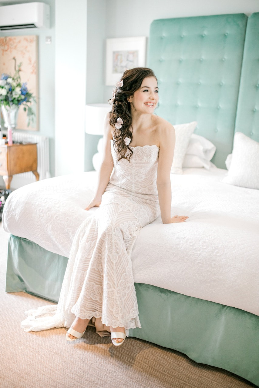 bride wearing a blush lace wedding dress and blush bridal hairpins