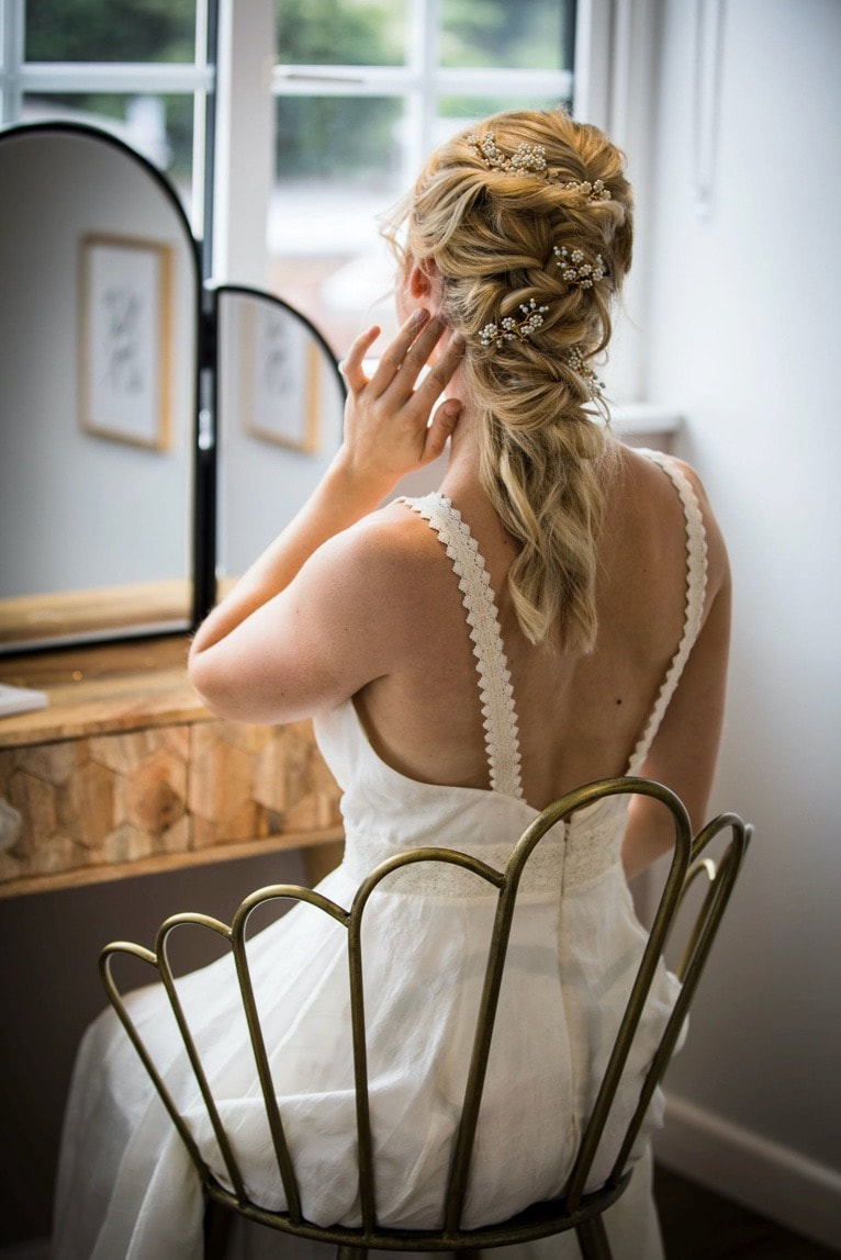 Bride at a mirror choosing bridal hair pins
