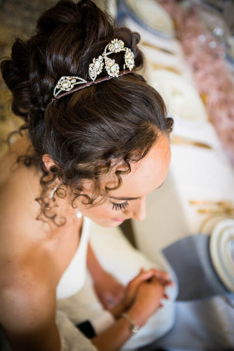 Bride wearing a sparkly tiara with crystal details, dark hair