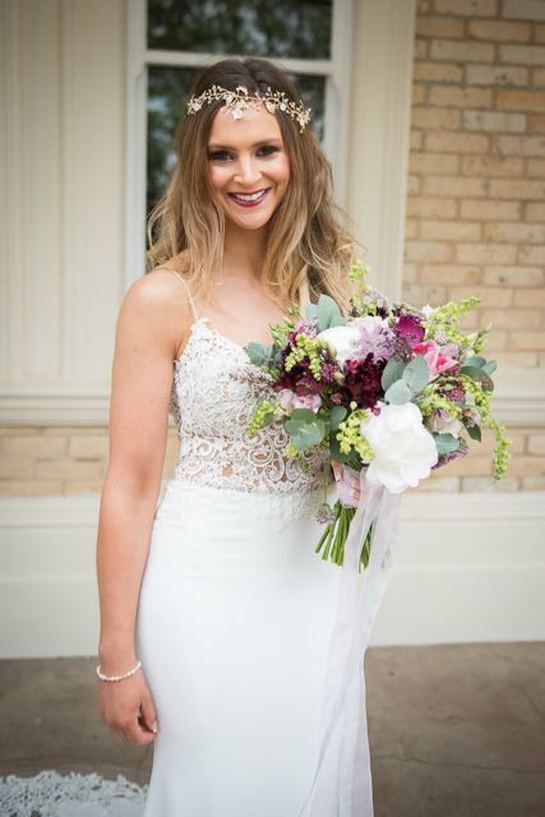 Bride holding her wedding bouquet at Beaconside House, Devon, wearing an Adele Vine.