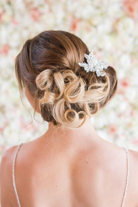 Bespoke hand embellished wedding hair comb pinned in a messy updo hair style