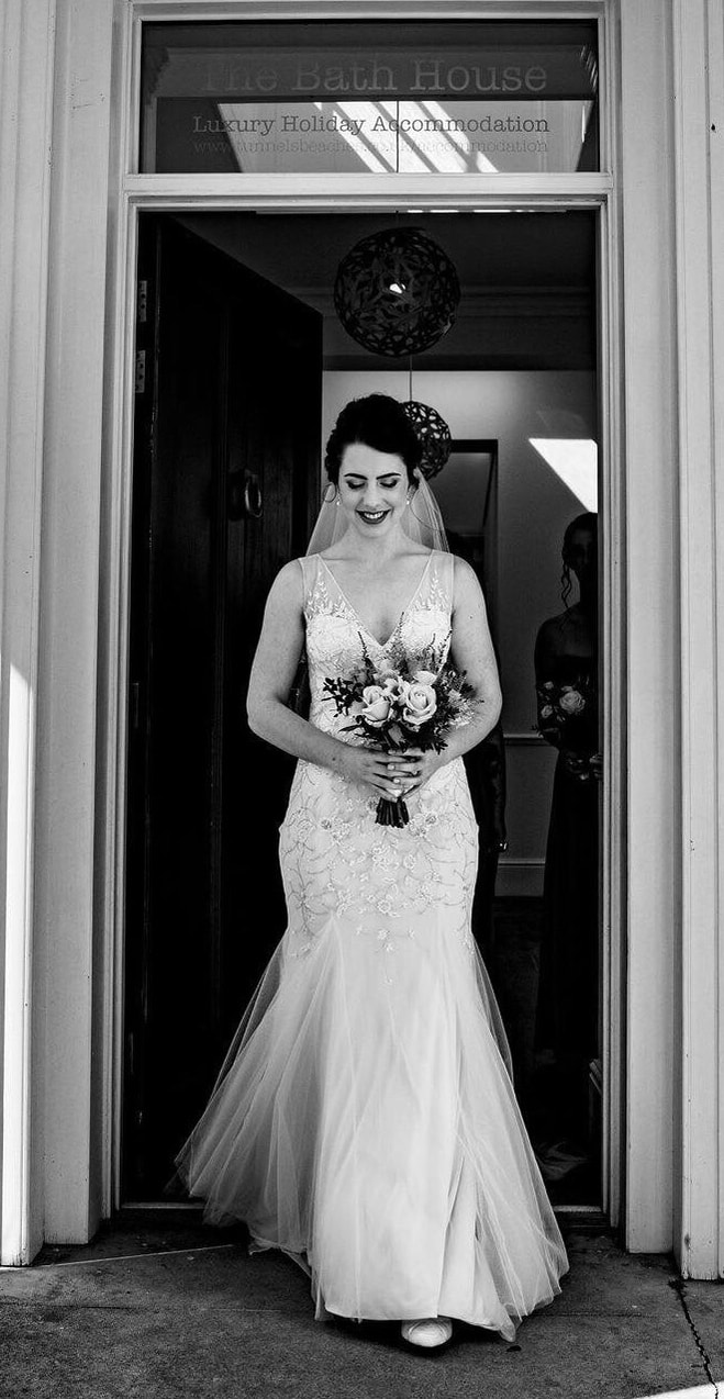 bride making her entrance black and white photo fishtail dress beaded details with a veil