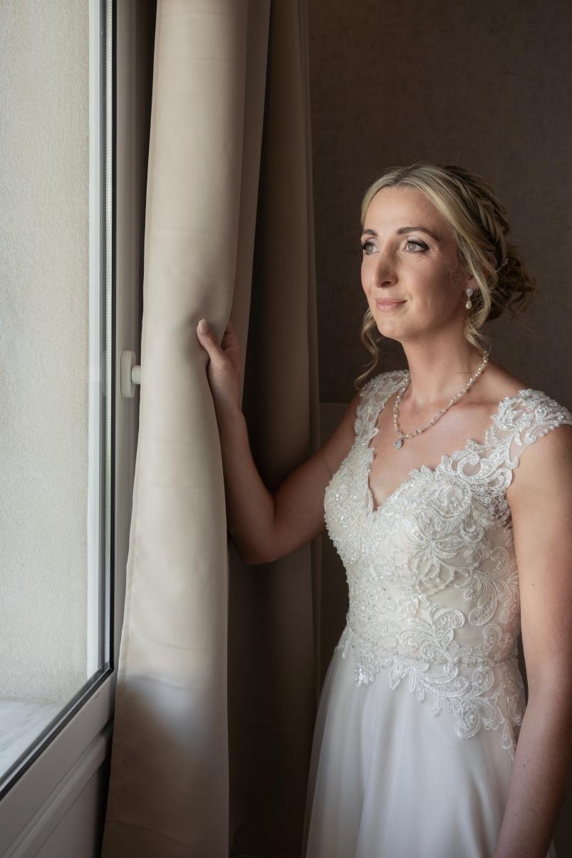 bespoke bride Megan wearing special wedding necklace and earrings and a pearl flower hairvine