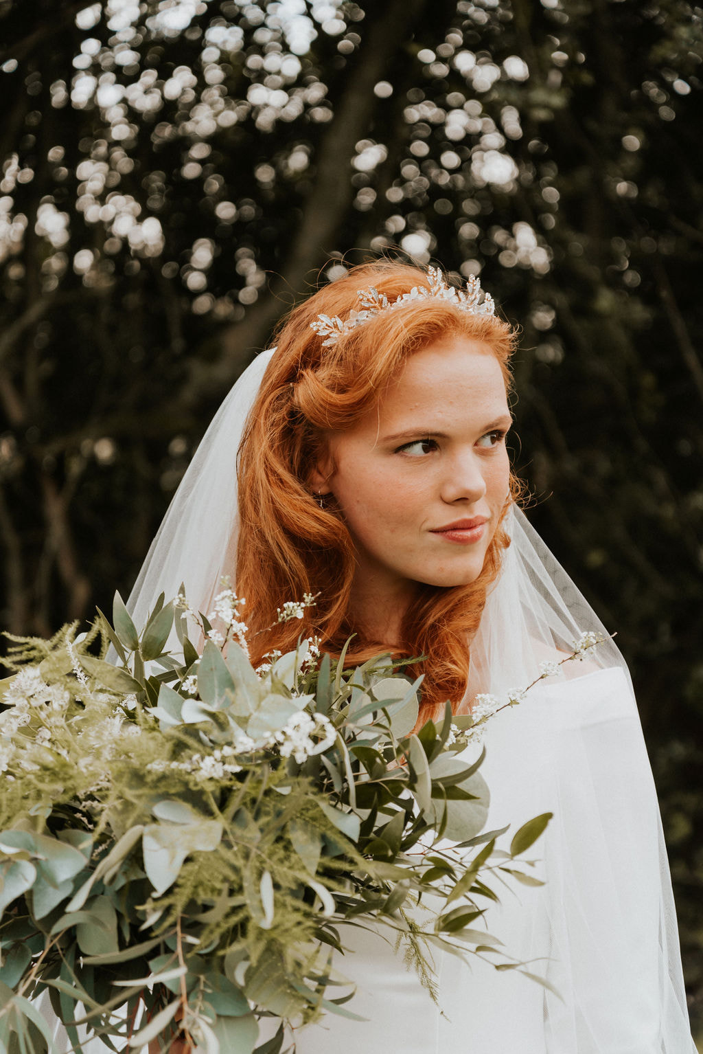 bride with auburn long hair and organic bridal crown, white veil and natural looking 